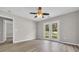 This is a bedroom with light grey walls, light wood floors and sliding glass doors at 1077 Stoney Falls Blvd., Myrtle Beach, SC 29579