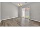 Bright dining room with modern chandelier, sliding glass door, and beautiful wood-look flooring at 1077 Stoney Falls Blvd., Myrtle Beach, SC 29579