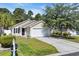 Charming single-story home with attached garage and well-maintained landscaping at 1077 Stoney Falls Blvd., Myrtle Beach, SC 29579