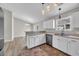 Kitchen with stainless steel appliances, white cabinetry, and a dining area with modern light fixtures at 1077 Stoney Falls Blvd., Myrtle Beach, SC 29579