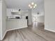 Open-concept living space with kitchen counter seating, modern light fixtures, and wood-look flooring at 1077 Stoney Falls Blvd., Myrtle Beach, SC 29579