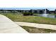 Picturesque community lake featuring a fountain, with walking path and grassy areas, offering a serene outdoor experience at 1083 Milford Way, Myrtle Beach, SC 29588