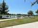 Scenic view of the community lake with benches, lush green space, and mature trees providing a relaxing atmosphere at 1083 Milford Way, Myrtle Beach, SC 29588