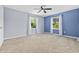 Spacious bedroom with neutral carpet, two bright windows, and blue accent walls at 109 Wofford Rd., Conway, SC 29526