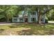 Charming two-story home featuring a red door and well-maintained landscaping in a serene, wooded setting at 109 Wofford Rd., Conway, SC 29526