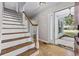 Inviting foyer with hardwood floors, white staircase and a view to the exterior at 109 Wofford Rd., Conway, SC 29526