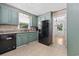 Charming kitchen featuring green cabinets, granite countertops, and black appliances at 109 Wofford Rd., Conway, SC 29526