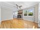 Living room with hardwood floors, a brick fireplace, and bright windows overlooking the pool at 109 Wofford Rd., Conway, SC 29526