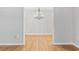 Spacious living room with beautiful hardwood floors and decorative chandelier at 109 Wofford Rd., Conway, SC 29526