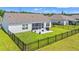 Backyard features a black fence, screened porch, and a patio with outdoor seating for relaxation and entertaining at 1108 Donald St., Conway, SC 29527
