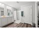 Bright bathroom with double sink vanity, framed mirrors, white cabinets, and a tiled walk-in shower at 1108 Donald St., Conway, SC 29527