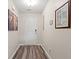 Inviting hallway features wood-look flooring and neutral paint scheme, leading to various rooms at 1108 Donald St., Conway, SC 29527