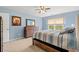 This comfortable main bedroom boasts blue walls, wood furniture, neutral carpet, and a large window at 1108 Donald St., Conway, SC 29527