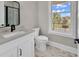 Bright bathroom features a marble vanity top and flooring plus a large window with natural light at 1112 Whispering Winds Dr., Myrtle Beach, SC 29579