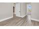Spacious bedroom featuring wood-look tile flooring and doorway views into an office and a bathroom at 1112 Whispering Winds Dr., Myrtle Beach, SC 29579
