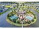 Aerial view of community amenities including a clubhouse, pool, tennis court, and lush landscaping at 1112 Whispering Winds Dr., Myrtle Beach, SC 29579