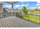 Relax on the expansive deck with black metal railing and enjoy views of the water and lawn at 1112 Whispering Winds Dr., Myrtle Beach, SC 29579