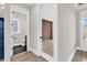 Hallway featuring contrasting tile and wood flooring with a view into the powder room and home office at 1112 Whispering Winds Dr., Myrtle Beach, SC 29579
