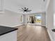 Open concept living room with hardwood floors, large sliding glass doors, and a modern ceiling fan at 1112 Whispering Winds Dr., Myrtle Beach, SC 29579