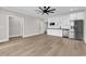 Spacious living room with modern flooring, white cabinets, stainless steel appliances, and ample counter space at 1112 Whispering Winds Dr., Myrtle Beach, SC 29579
