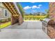 Outdoor patio with built-in grill, brickwork, a pond view, and stairs leading to a deck at 1112 Whispering Winds Dr., Myrtle Beach, SC 29579