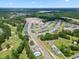 Aerial view of a community boasting new homes, a swimming pool, and lush green spaces at 1115 Rosefield Way, Calabash, NC 28467