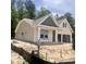 A charming one-story home under construction, featuring a two-car garage and inviting front porch at 1115 Rosefield Way, Calabash, NC 28467