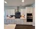 Modern kitchen featuring white cabinets, stainless steel appliances, and a stylish backsplash at 1115 Rosefield Way, Calabash, NC 28467