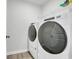 Well-equipped laundry room with modern washer and dryer units and storage shelf at 113 Arbor Crest Ln., Tabor City, NC 28463