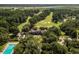 Aerial view of the estate featuring a pool, beautiful landscaping, and picturesque golf course at 116 Capt Anthony White Ln., Georgetown, SC 29440