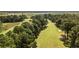Aerial image shows a lush green golf course bordering a waterway with towering trees on either side at 116 Capt Anthony White Ln., Georgetown, SC 29440