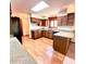 Traditional kitchen featuring hardwood floors, granite countertops, and modern black appliances at 116 Capt Anthony White Ln., Georgetown, SC 29440