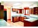 Traditional kitchen features wood cabinets, granite counters, and a bright, airy atmosphere with a skylight at 116 Capt Anthony White Ln., Georgetown, SC 29440
