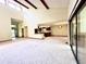 Open-concept living space with high ceilings, wooden beams, and sliding door access at 116 Capt Anthony White Ln., Georgetown, SC 29440