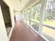 Relaxing sun room with lots of windows, ceiling fan, skylight, and access to the outdoors at 116 Capt Anthony White Ln., Georgetown, SC 29440