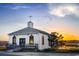 Scenic sunset view of a charming white church with a cross and a flock of birds flying overhead at 118 Goodson Loop, Pawleys Island, SC 29585