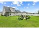 Spacious backyard featuring a patio with outdoor seating, well-kept lawn, and garden beds surrounding the area at 120 River Country Dr., Conway, SC 29526
