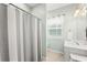 Bathroom featuring tiled floors, a gray shower curtain, and a window at 120 River Country Dr., Conway, SC 29526