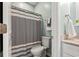 This bathroom features a shower with grey curtain, toilet and sink with stone countertop at 120 River Country Dr., Conway, SC 29526