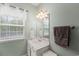 Updated bathroom with a window, light fixtures, and framed mirror at 120 River Country Dr., Conway, SC 29526