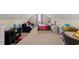 Spacious bedroom with carpet flooring, a queen bed, and a black couch at 120 River Country Dr., Conway, SC 29526