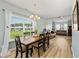 Bright dining room with large windows, a chandelier, and an open view into the living room at 120 River Country Dr., Conway, SC 29526