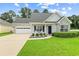 Charming single-story home featuring a well-manicured lawn, brick accents, and a two-car garage at 120 River Country Dr., Conway, SC 29526
