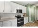Modern kitchen with stainless steel appliances, white cabinets, and an inviting atmosphere at 120 River Country Dr., Conway, SC 29526