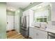 This is an open kitchen and entry way, with stainless steel appliances, white cabinets and hardwood floors at 120 River Country Dr., Conway, SC 29526