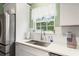 This is a kitchen sink with a view, featuring stainless steel appliances and white cabinetry at 120 River Country Dr., Conway, SC 29526
