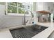 Close-up view of a modern, stainless steel kitchen sink and faucet under a window at 120 River Country Dr., Conway, SC 29526