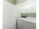 This is a laundry room with cabinets and modern washer and dryer at 120 River Country Dr., Conway, SC 29526