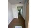 Bright hallway featuring white walls and doors leading to various rooms, showcasing the home's layout at 1225 Lady Bird Way, North Myrtle Beach, SC 29582