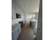 Open kitchen layout with grey cabinets, island with marble countertop, and view of the living space at 1225 Lady Bird Way, North Myrtle Beach, SC 29582